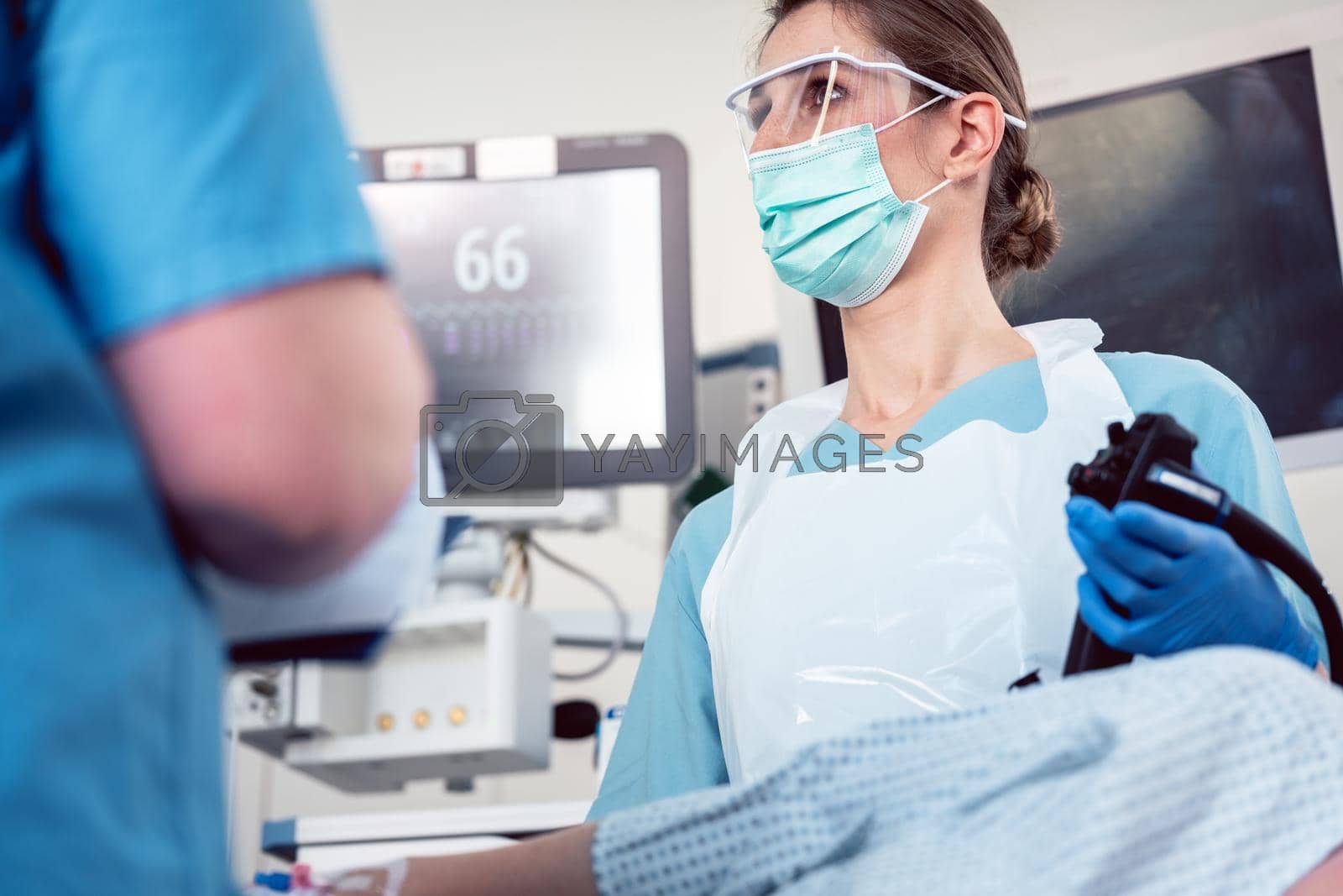 Royalty free image of Internal specialist doctor operating endoscope in colonoscopy by Kzenon