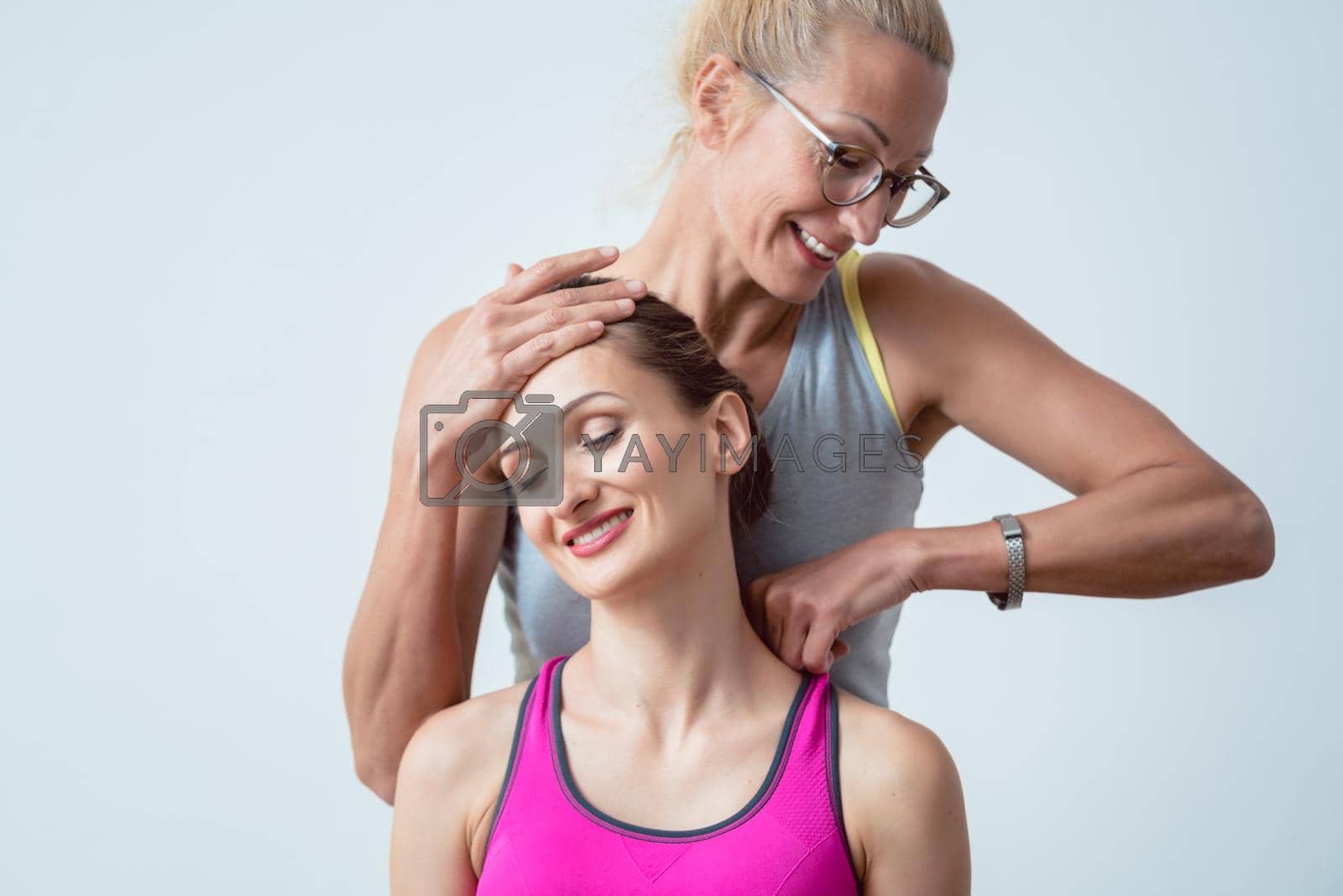 Royalty free image of Physical therapist working on head and shoulders of patient by Kzenon