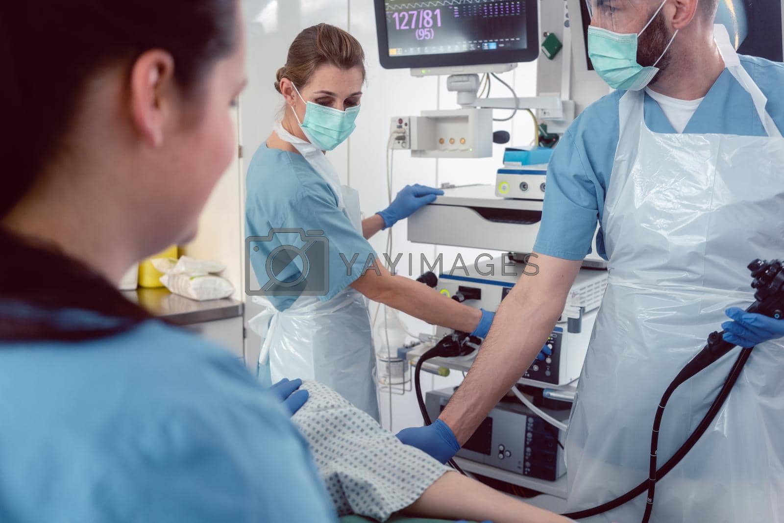 Royalty free image of Doctor during endoscopy checking picture of mouth on screen by Kzenon
