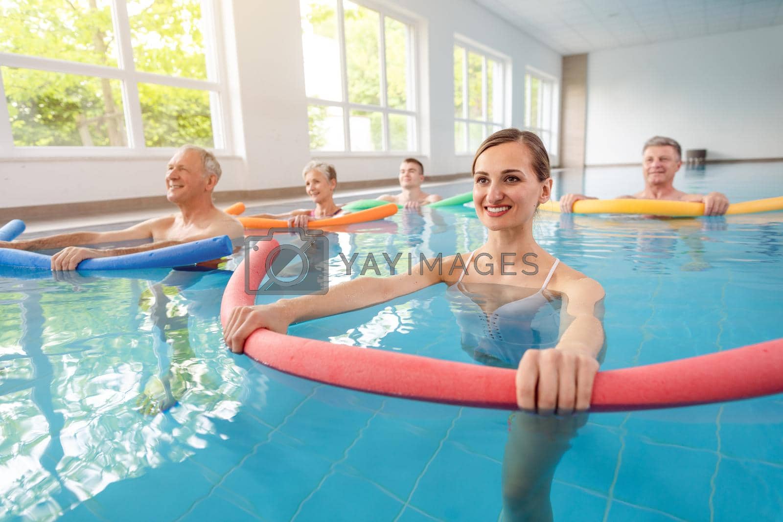 Royalty free image of Patients during remobilization in a health center doing aquarobics by Kzenon