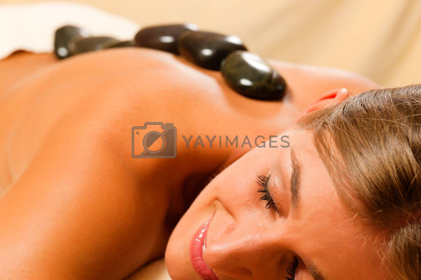 Royalty free image of Woman having a hot stone therapy session by Kzenon