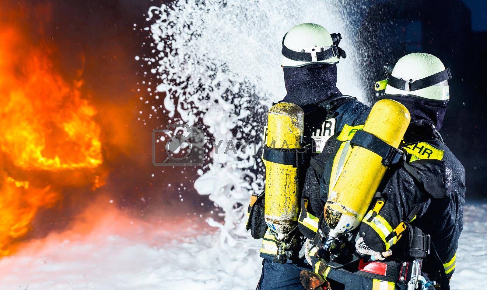 Royalty free image of Firefighter - Firemen extinguishing a large blaze by Kzenon