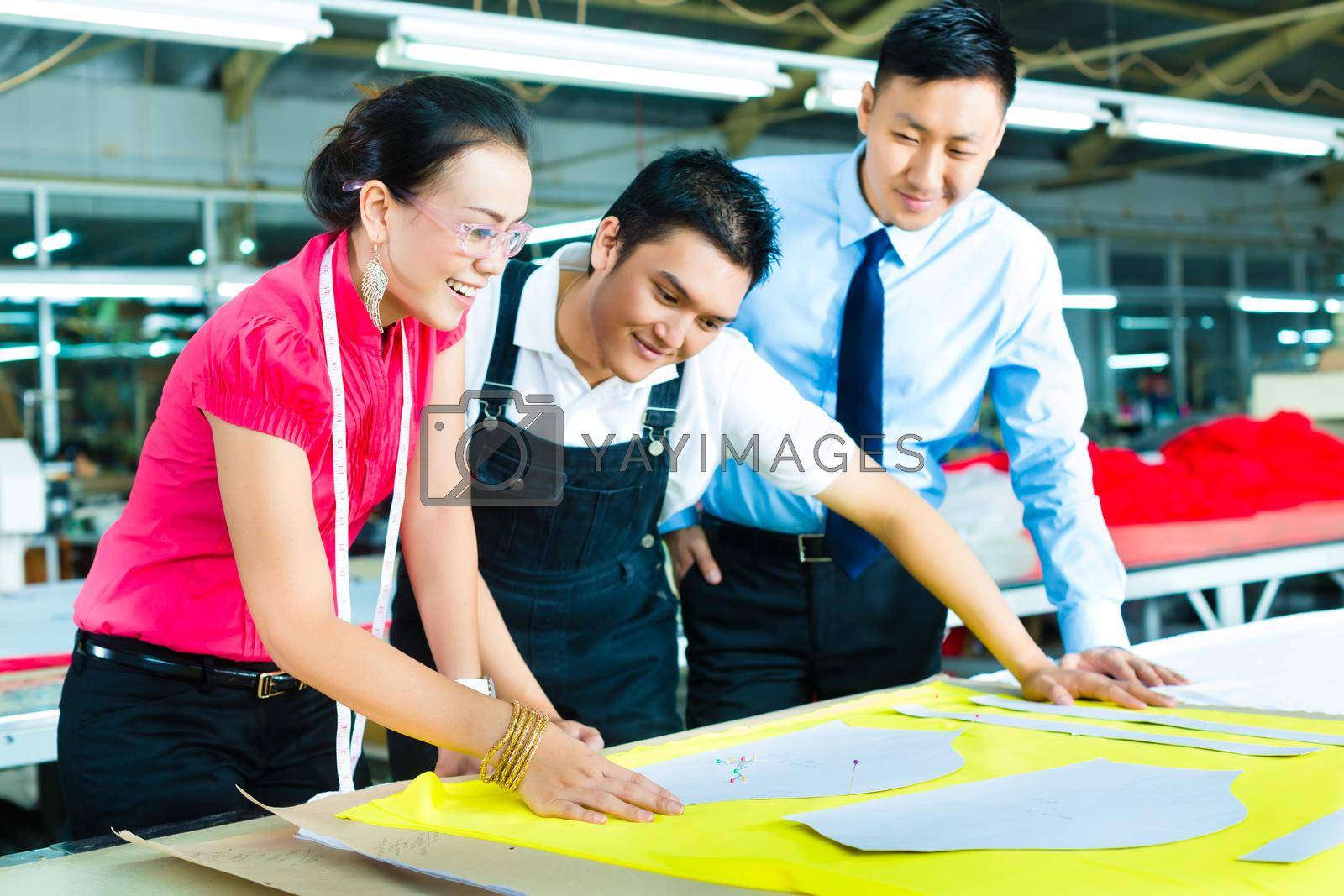 Royalty free image of Worker, Dressmaker and CEO in a factory by Kzenon