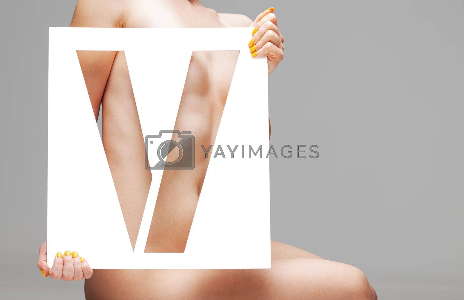 Royalty free image of nude girl holding stencil letter v by kokimk