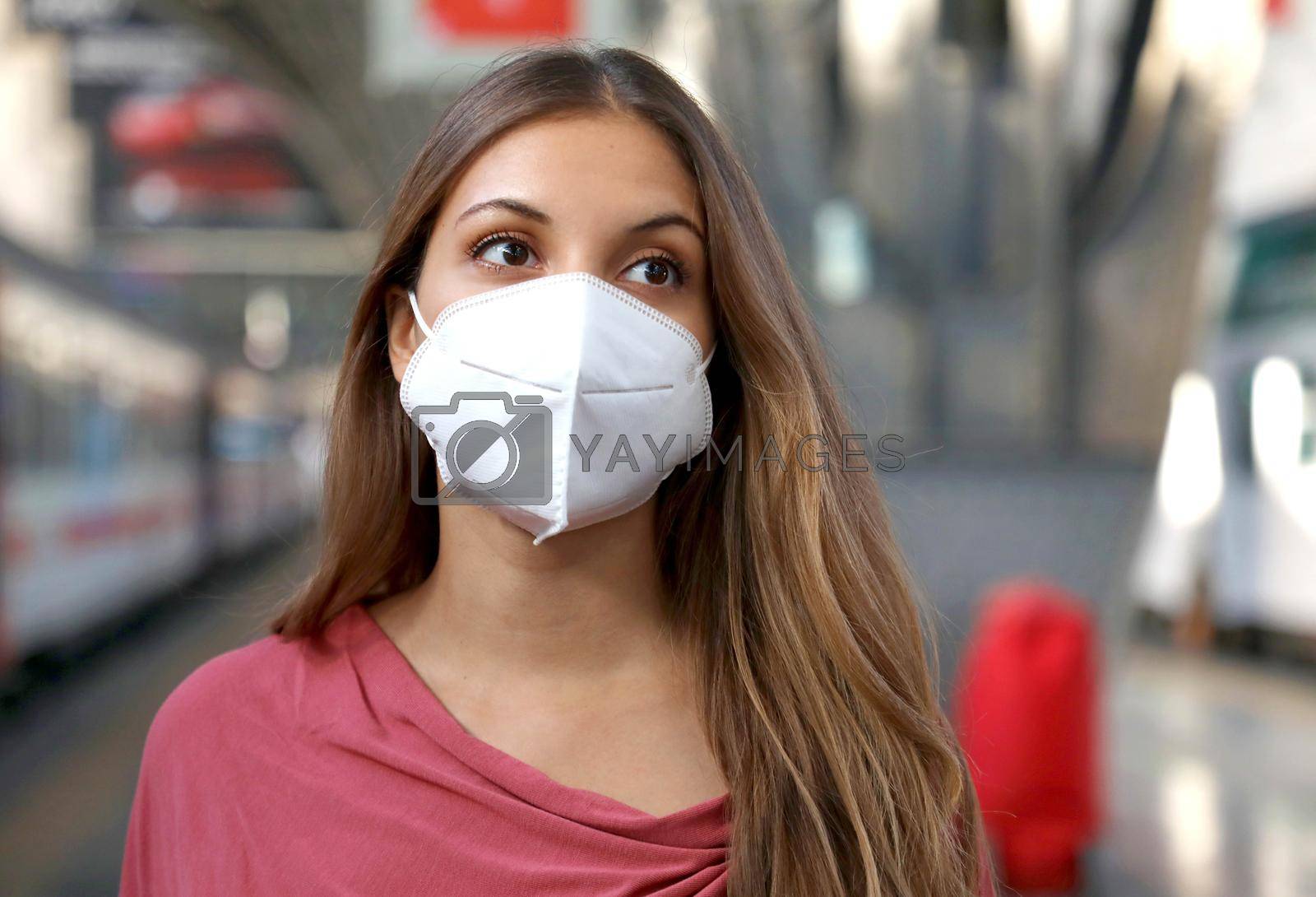 Close up of casual woman waiting train with KN95 FFP2 protective mask at train station