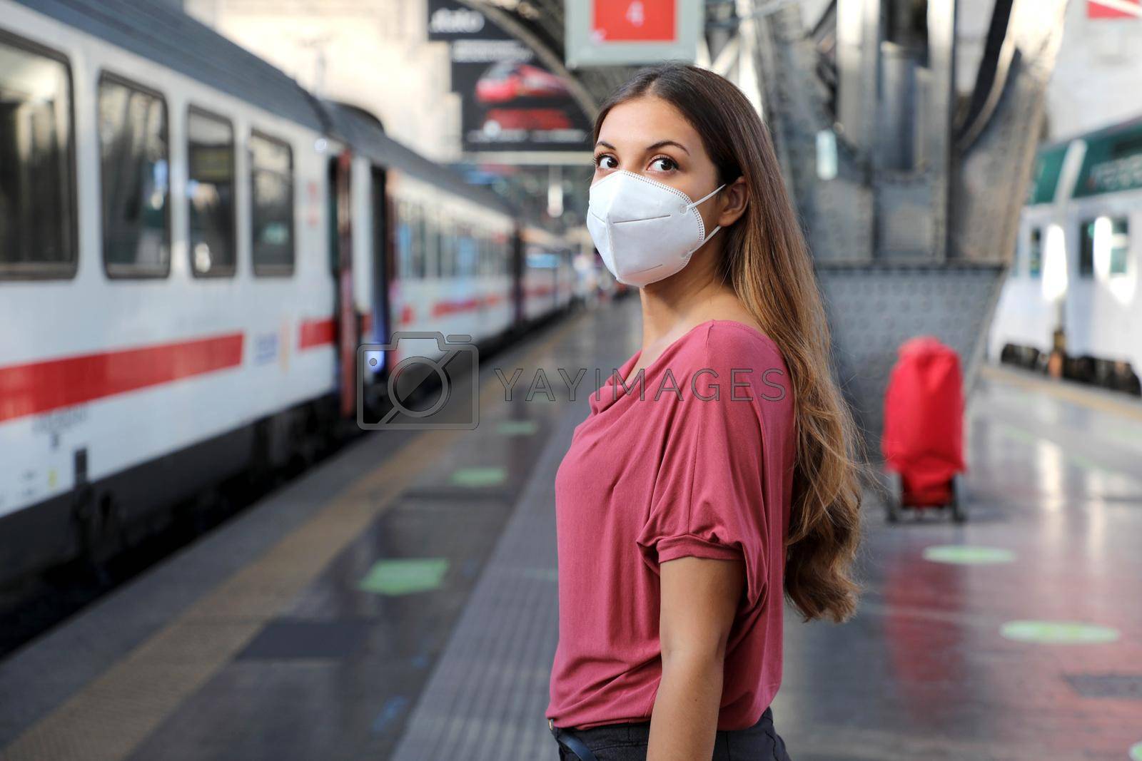 Portrait of casual woman waiting train with KN95 FFP2 protective mask at train station