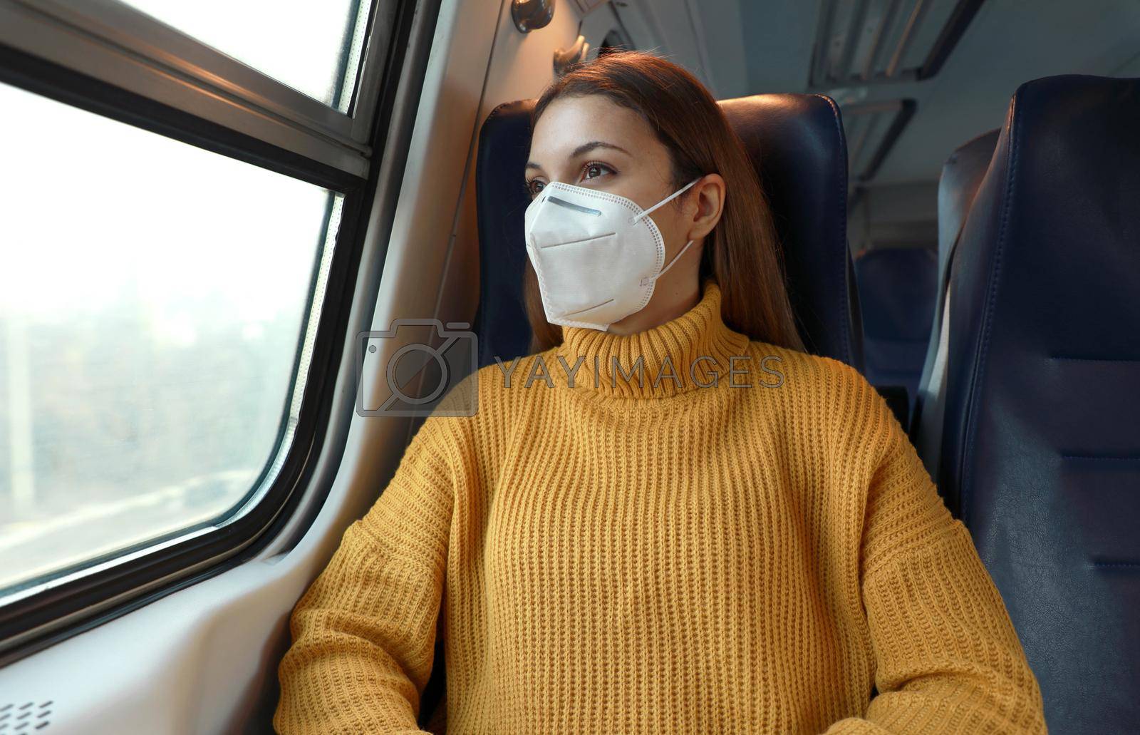New normal. Passenger in protective mask standing in the train respecting health and safety rules.