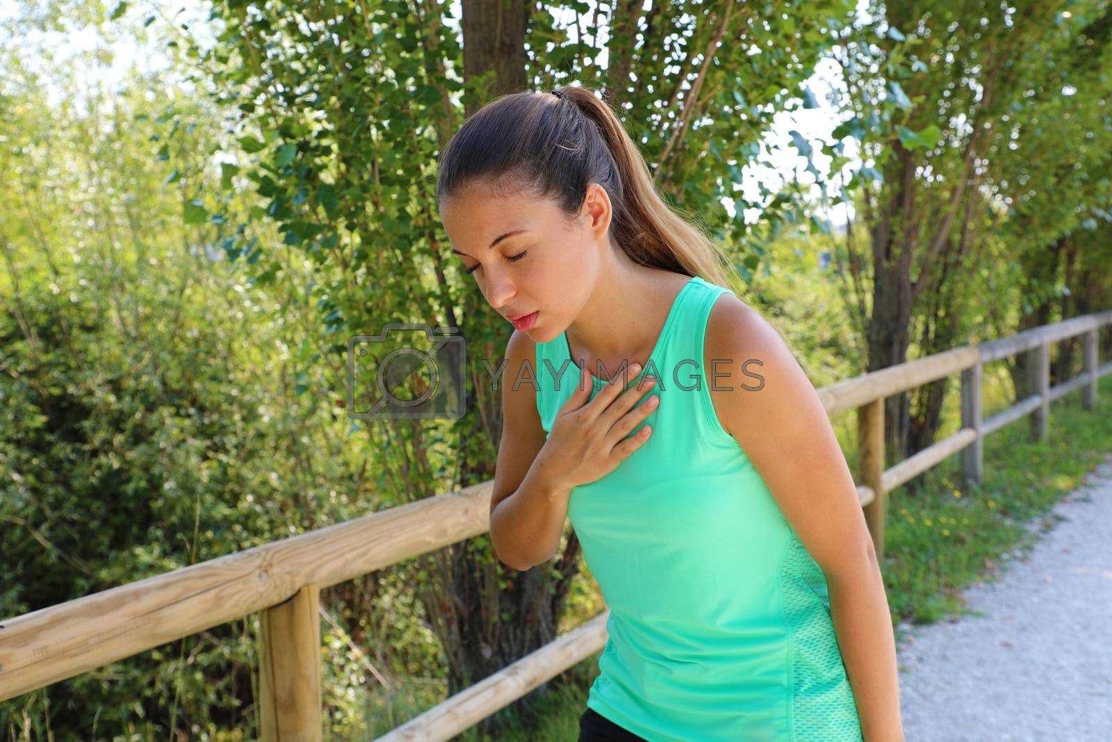 Royalty free image of Running nausea. Nauseous and sick ill runner vomiting. Running woman feeling bad about to throw up. Girl having nausea from dehydration or chest pain. by sergio_monti