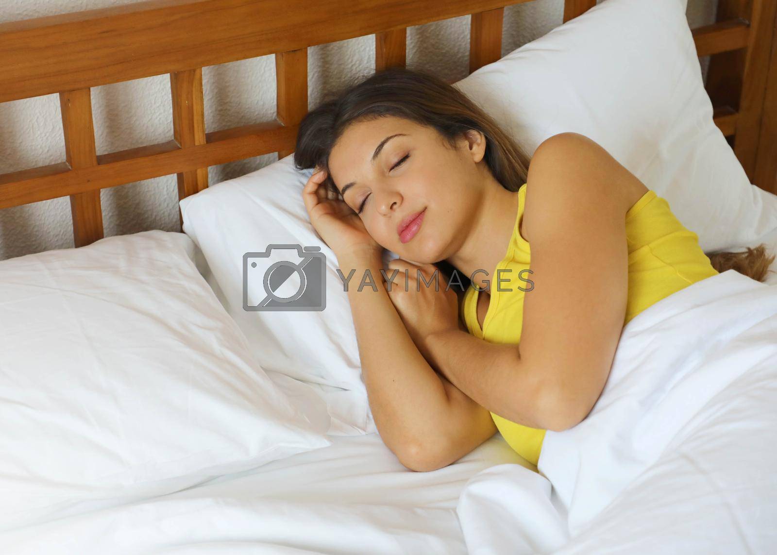 Royalty free image of Brazilian woman sleeping in bed in white comfortable sheets at home by sergio_monti