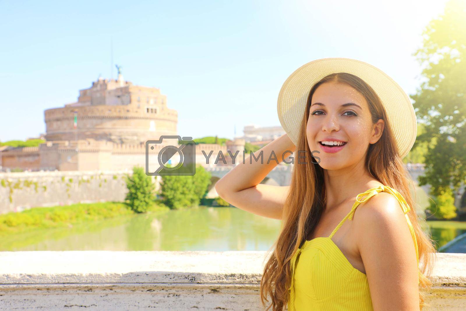 Holidays in Italy. Smiling beautiful tourist girl in Rome, Italy. Attractive fashion woman with Castel Sant Angelo castle on the background.