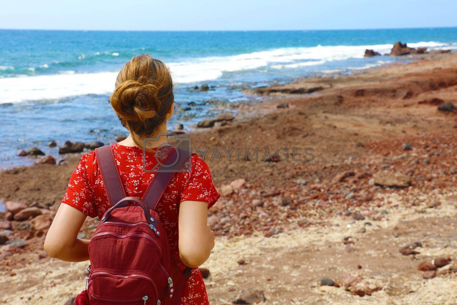 Travel holiday adventure in Tenerife. Back view beautiful young woman breathing and enjoying Tenerife coast. Copy space.