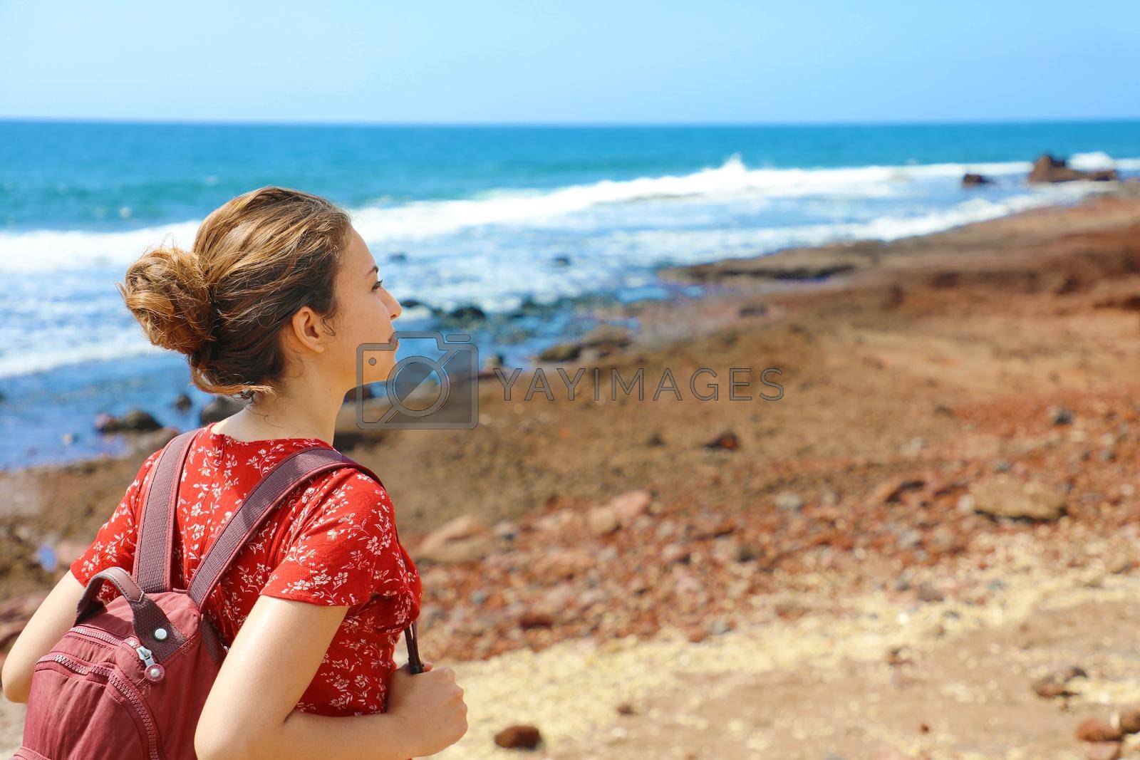 Young backpacker exploring Tenerife Island in her travel vacation on Canary Islands. Copy space.