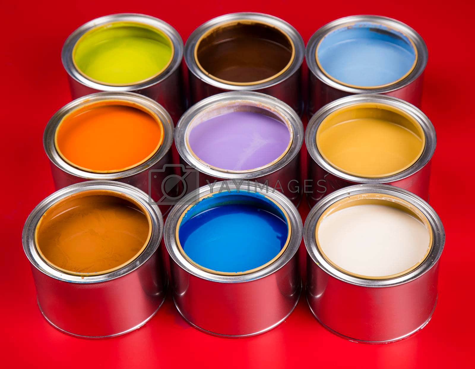Royalty free image of Buckets full of rainbow colored oil paint by JanPietruszka