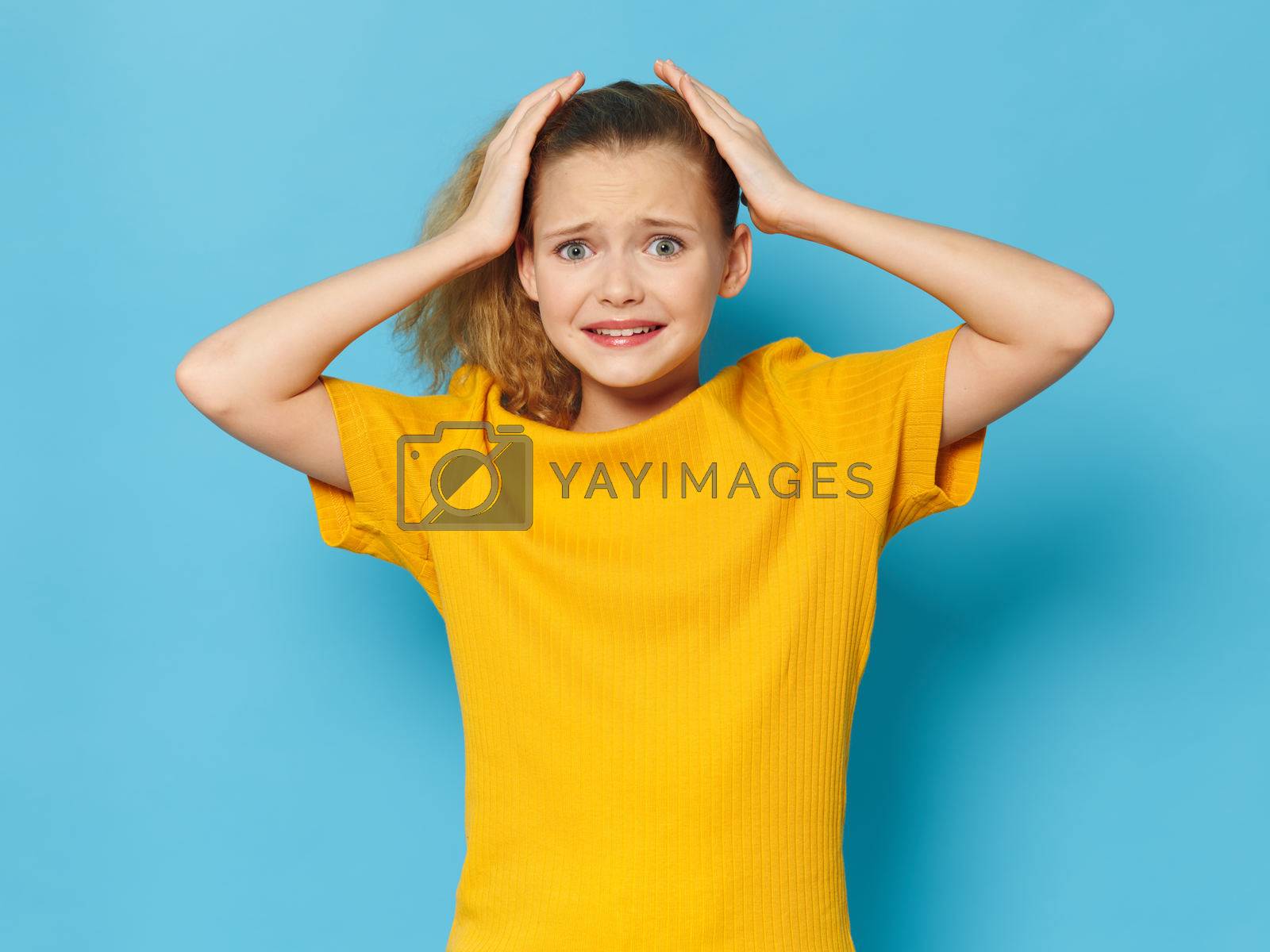 Royalty free image of frightened girl touching her head with hands by SHOTPRIME