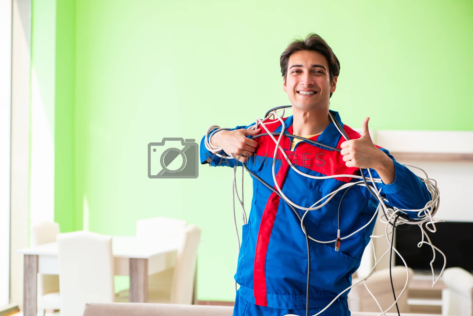 Royalty free image of Electrician contractor with tangled cables by Elnur