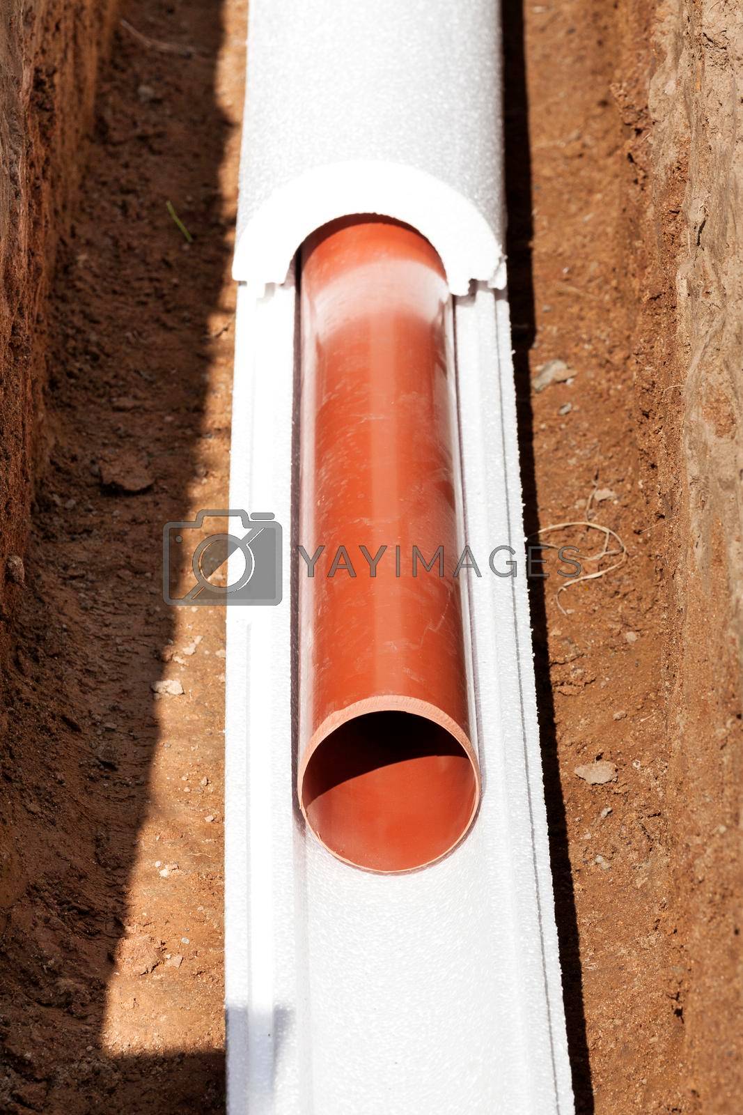 Royalty free image of Installation of water main, sanitary sewer, storm drain systems, plastic pipes wrapped in insulation by Nobilior