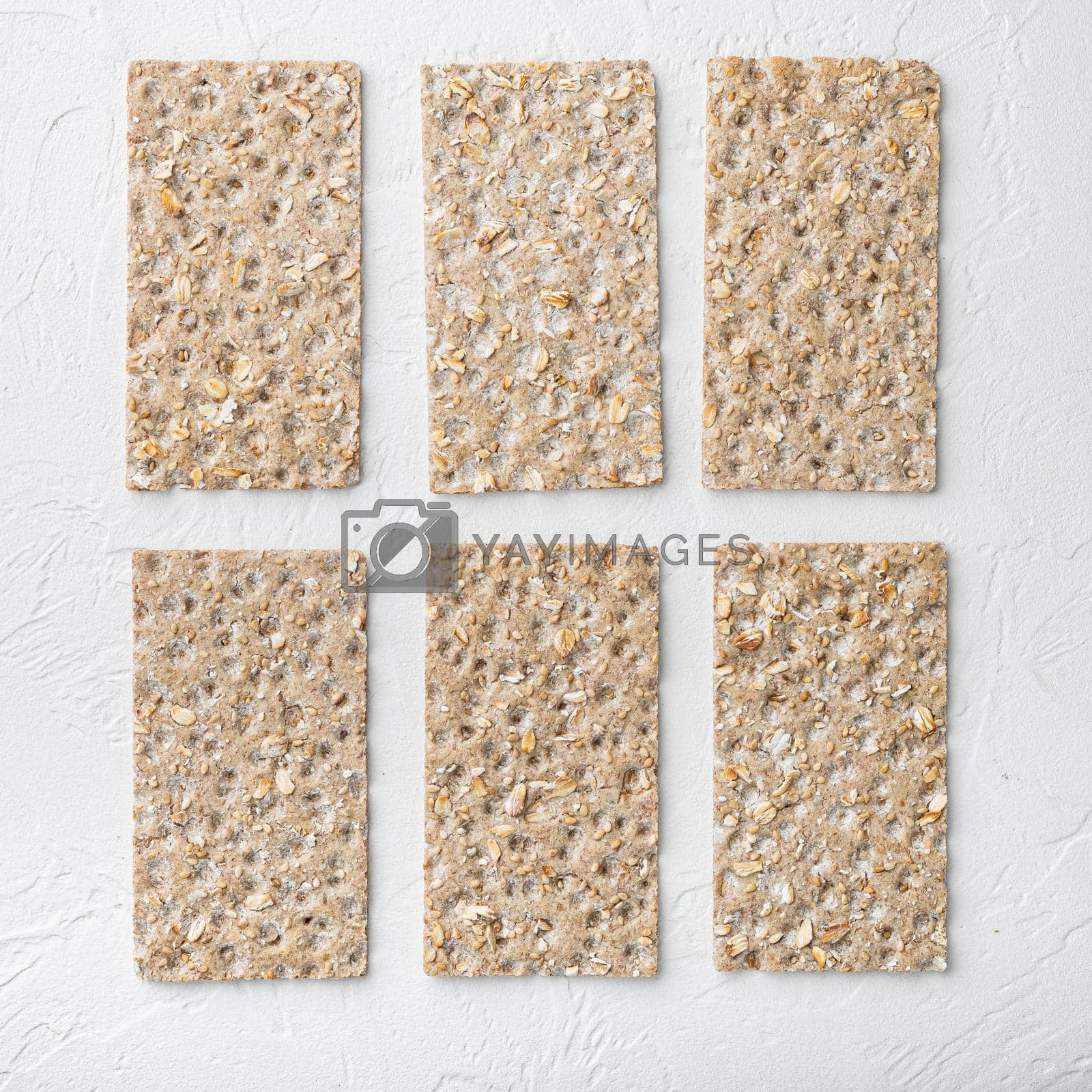 Royalty free image of Grain diet light crisp bread, square format , on white stone table background, top view flat lay, with copy space for text by Ilianesolenyi