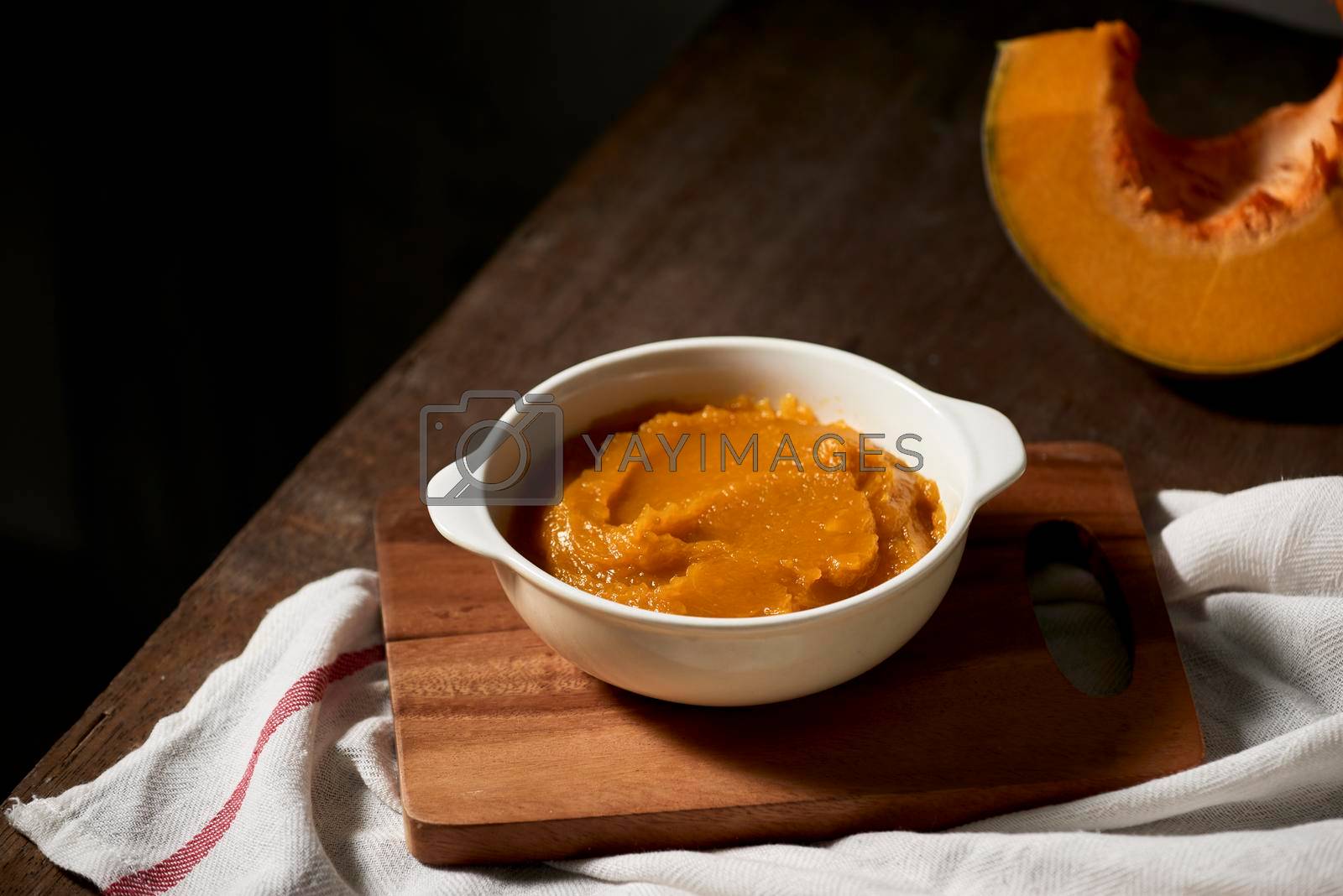 Royalty free image of Pumpkin puree in a bowl on wooden background by makidotvn
