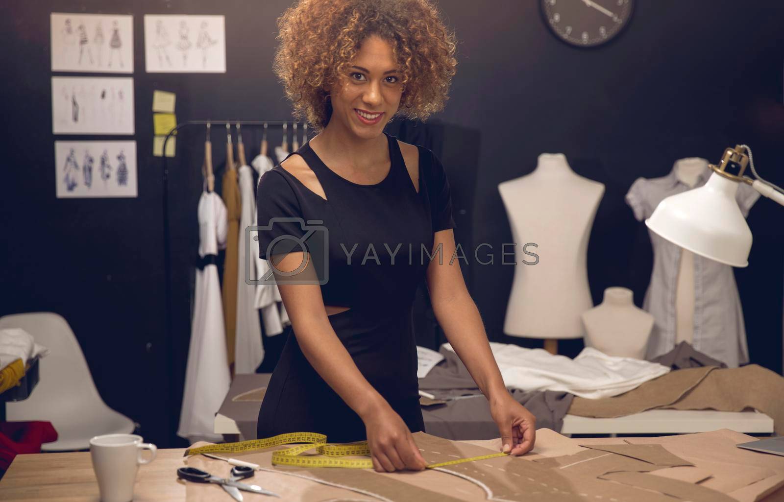 A young fashion designer working on her atelier