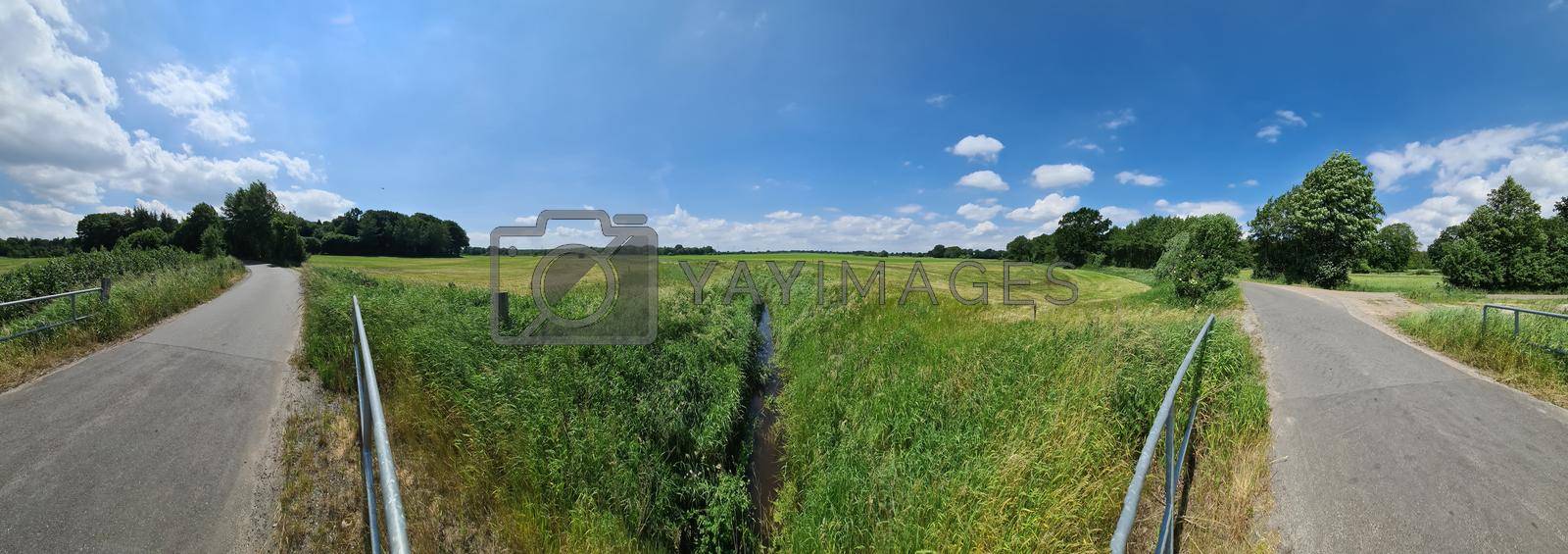 Panorama of countryside roads with fields and trees in northern europe.