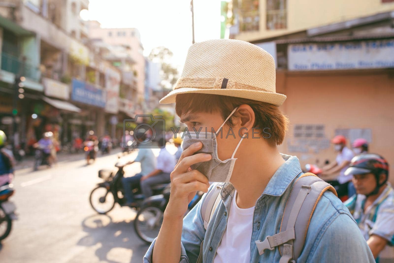 Royalty free image of Young Asian man living in city with polluted air by makidotvn