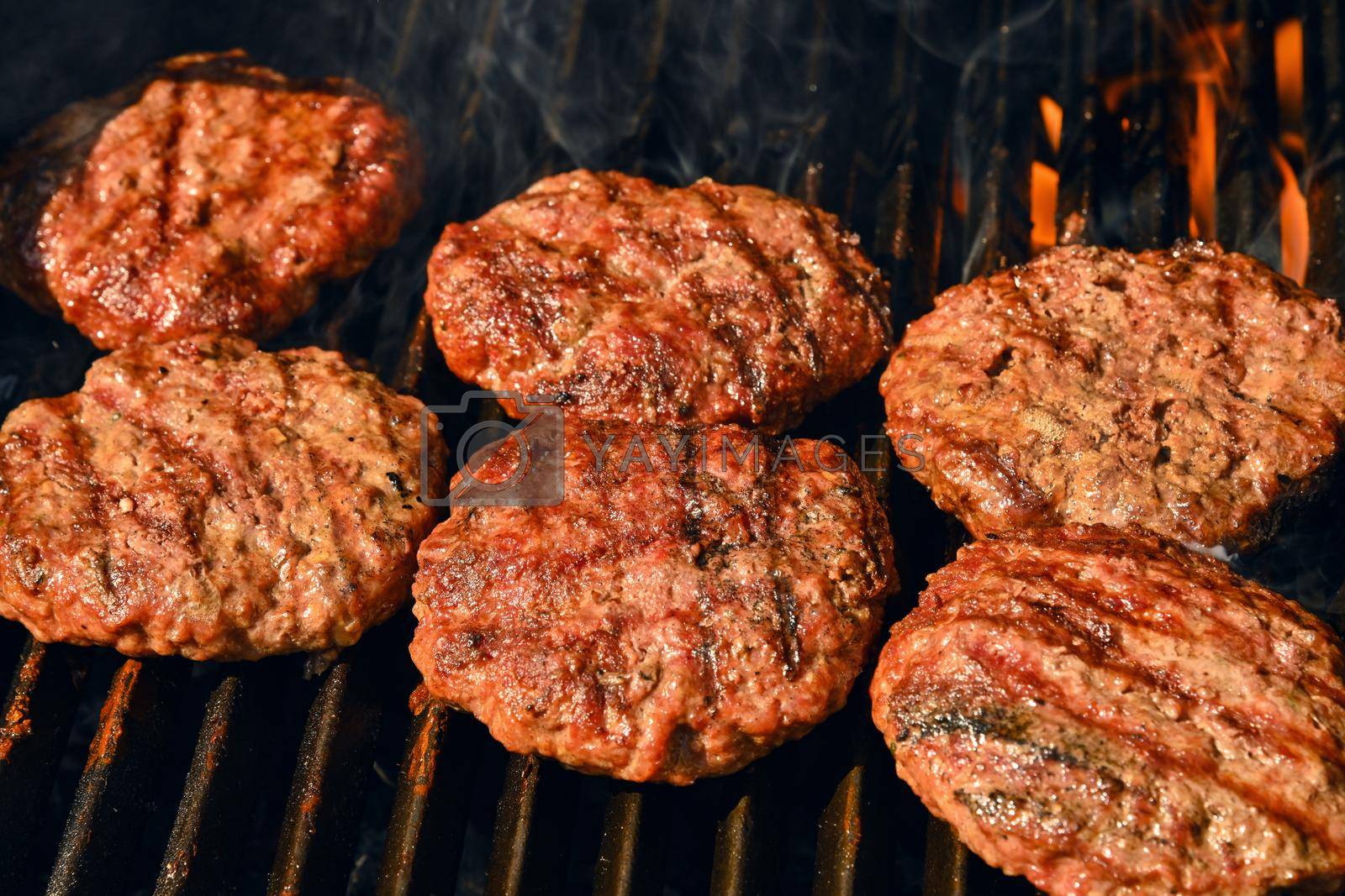 Royalty free image of Beef burger for hamburger on barbecue grill by BreakingTheWalls