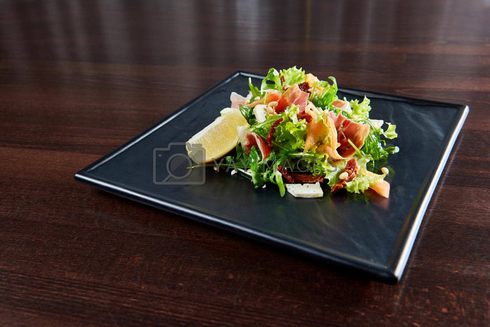 Royalty free image of Arugula and prosciutto salad served at the restaurant by SerhiiBobyk