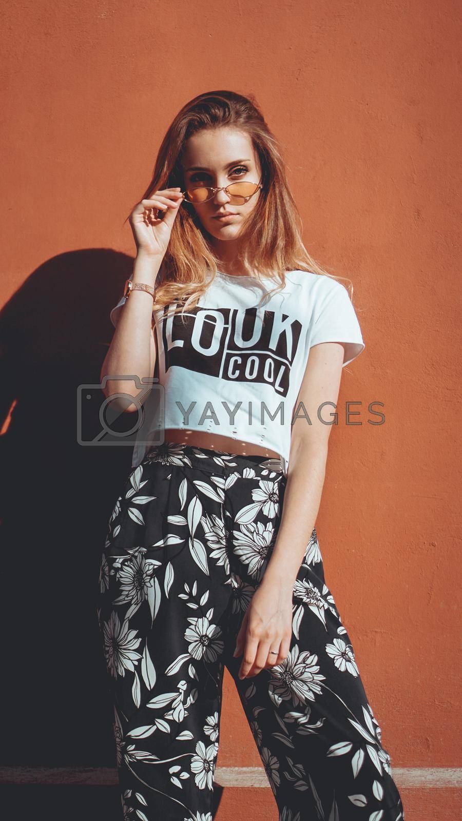 Royalty free image of Fashion portrait stylish pretty woman in sunglasses posing in the city by natali_brill
