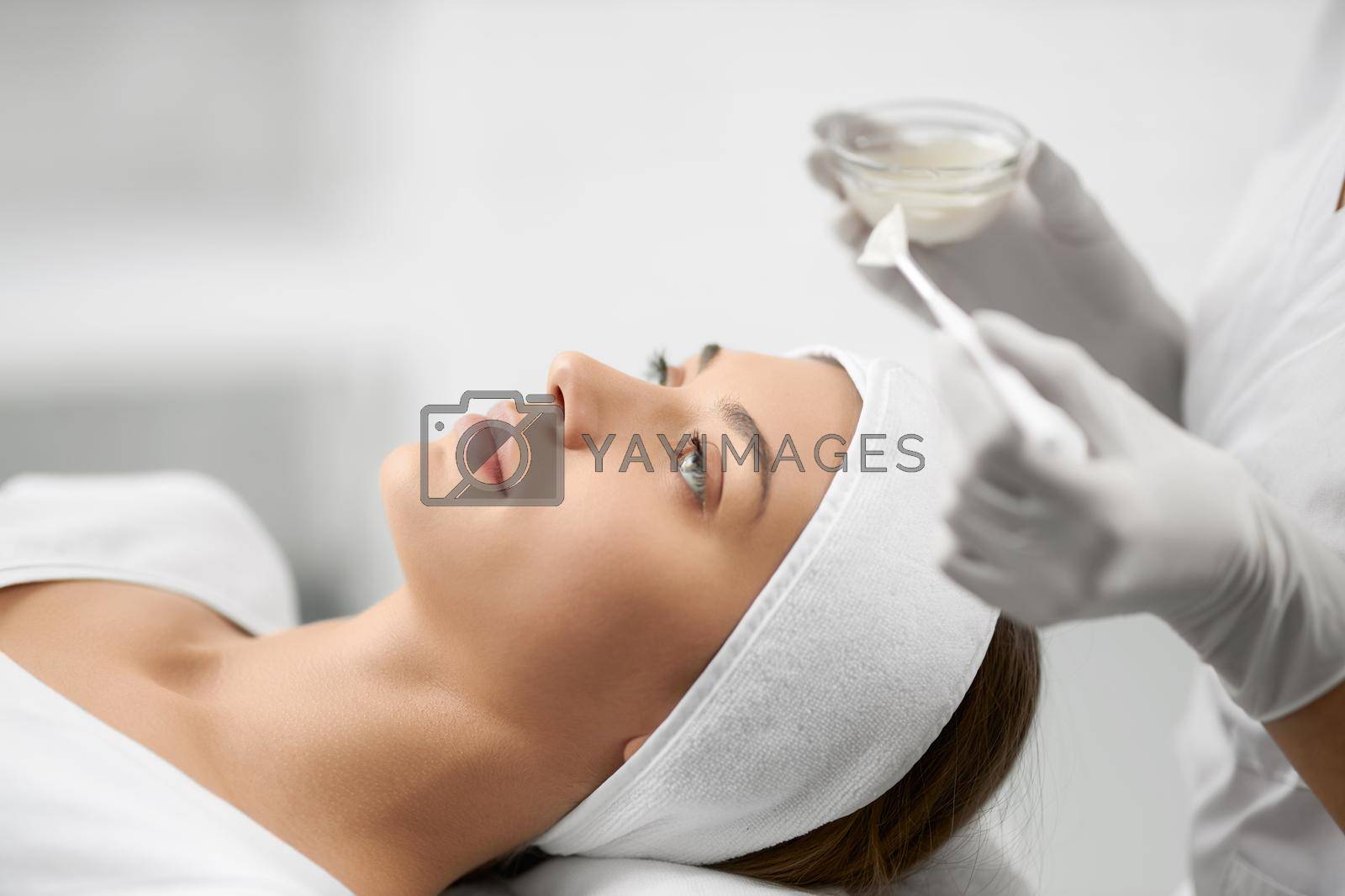 Royalty free image of Beautiful woman doing procedure for face in beautician.  by SerhiiBobyk