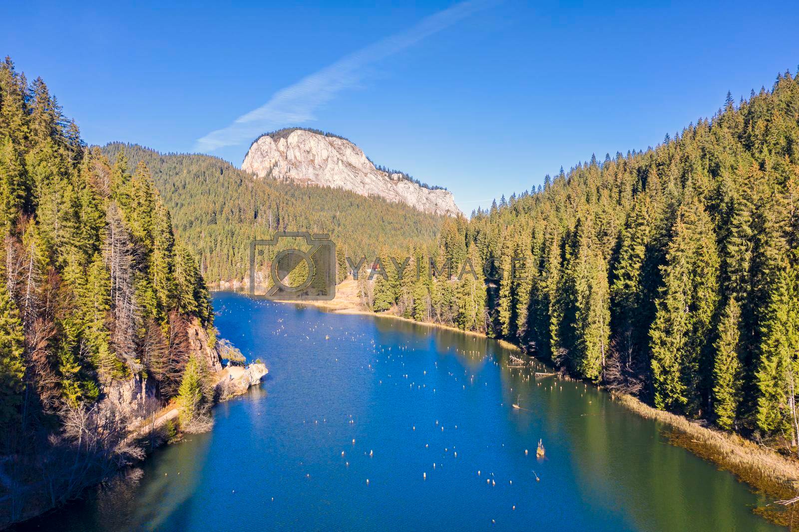 Aerial view of mountain lake in Romanian Carpathians. Red Lake is a natural dam lake in Romania located in the north-east where you can still see the tree stumps.