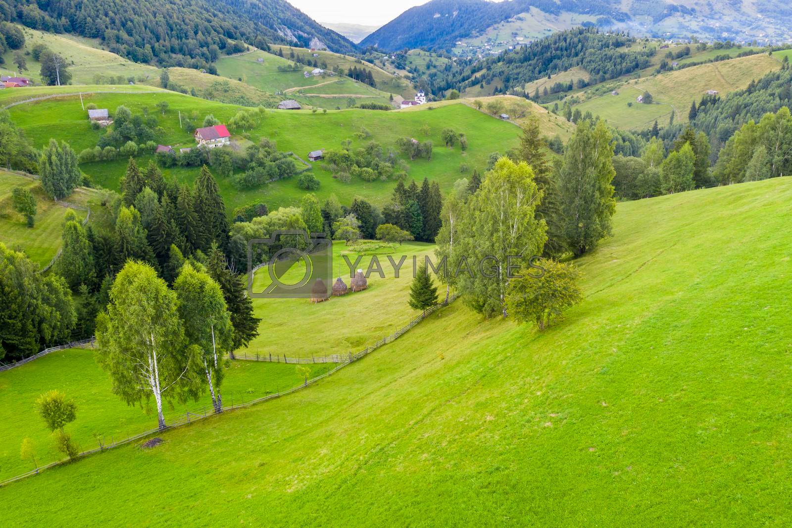 Beautiful aerial landscape from a traditional mountain village from Romanian Carpathians, Bran valley summer scene in Transylvania