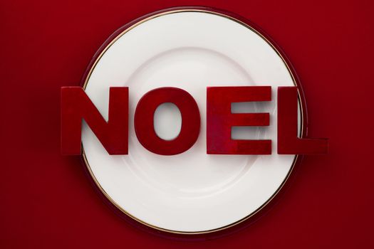 white plate with word noel