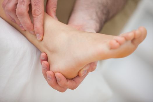 Barefoot being massaged by a doctor