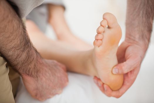 Barefoot being touched by a physiotherapist