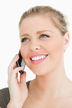 Pretty woman calling with her smartphone against a white background