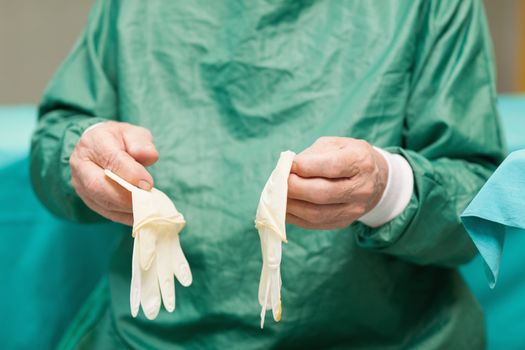 Surgeon holding surgical gloves