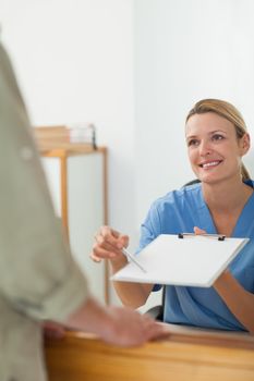Nurse asking the signature of a patient