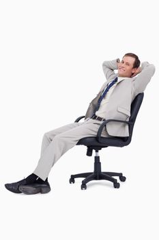 Side view of smiling businessman leaning back in his chair
