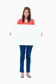 Teenager holding a blank poster against a white background