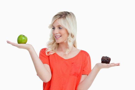 Woman imitating the food-balance to choose between an apple and 