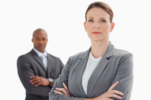 Businesswoman with folded arms in front of businessman with fold