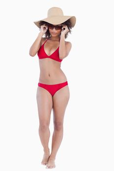 Attractive young woman in beachwear standing upright