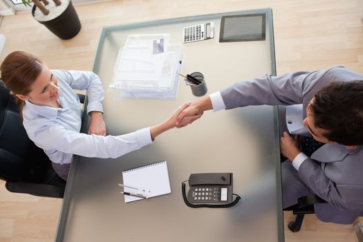 Above view of consultant shaking hands with customer
