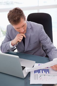 Businessman looking at market research results