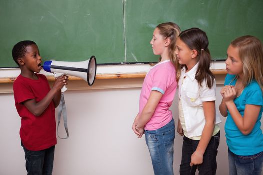 Schoolboy yelling through a megaphone to his classmates