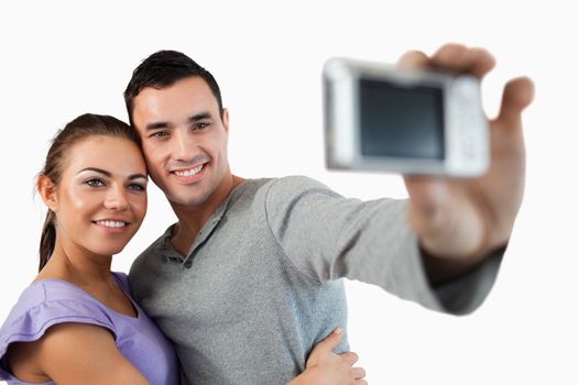 Young couple taking photograph of themselves