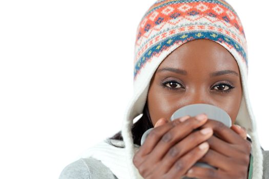 Student woman enjoying a cup of tea in the cold against a white background