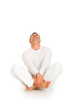 man dressed in white sitting on the floor