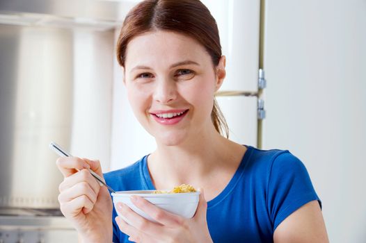 woman eating cereal with milk
