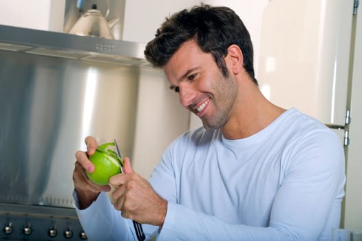 man peeling an apple